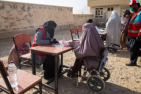 Frau im Rollstuhl bei Verteilung von Hilfgütern & Bargeld in Afghanistan