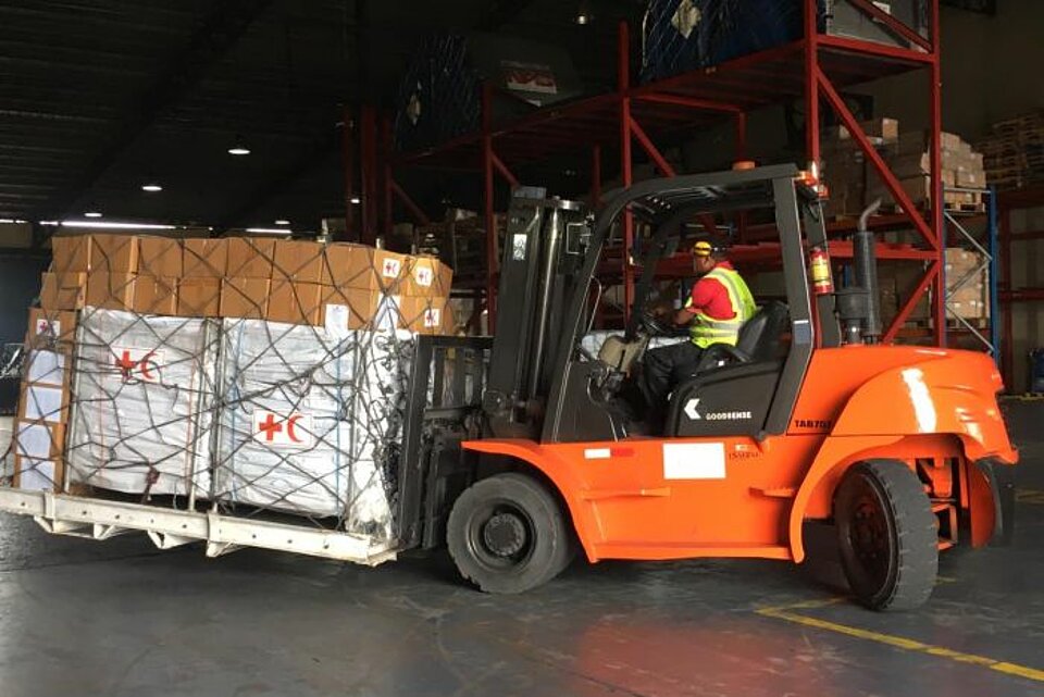 Gabelstapler bei Beladung eines Flugzeugs mit Hilfsgütern im Rotkreuz-Logistikzentrum in Panama