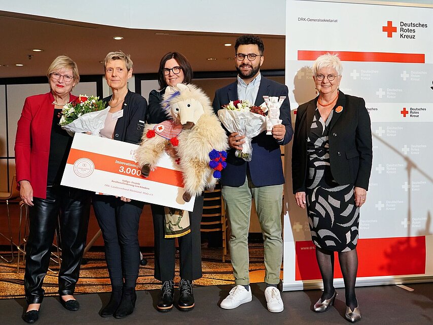Verleihung des DRK - Innovationspreises 2023 im Rahmen der Bundesversammlung an das Indigo Projekt zur Stärkung der Resilienz bei Kindern vom DRK-Landesverband Rheinland-Pfalz e.V..  Preisverleihung durch die Präsidentin Gerda Hasselfeldt. V.l. DRK - Vizepräsidentin Ulrike Würth, die Vorstandsvorsitzende des Landesverbandes Anke Marzi, die Preisträger, Gerda Hasselfeldt