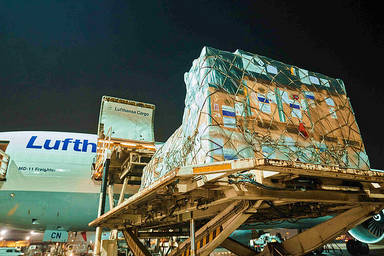 Kisten auf Paletten vor Flugzeug