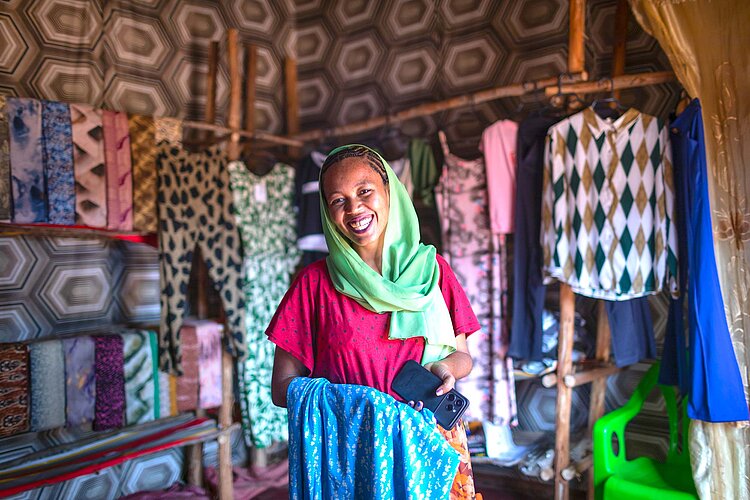 Frau vor aufgehängten Stoffen