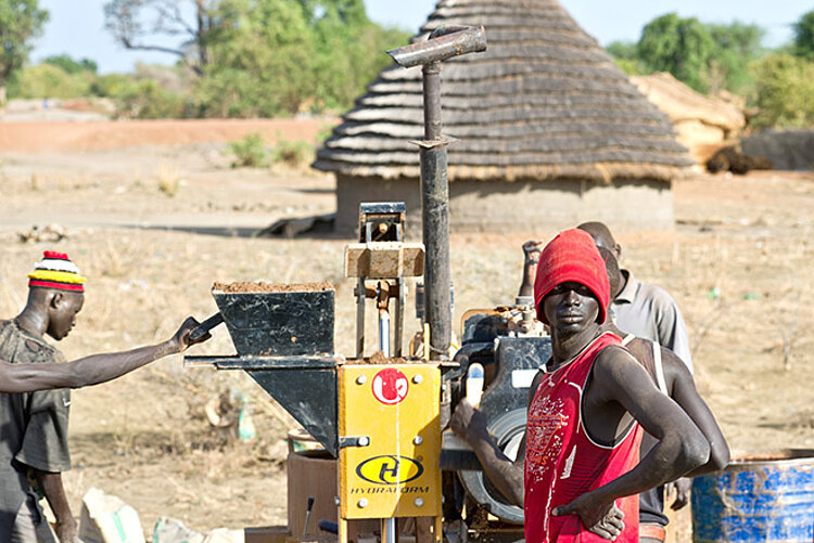 young south sudanese at a building machine