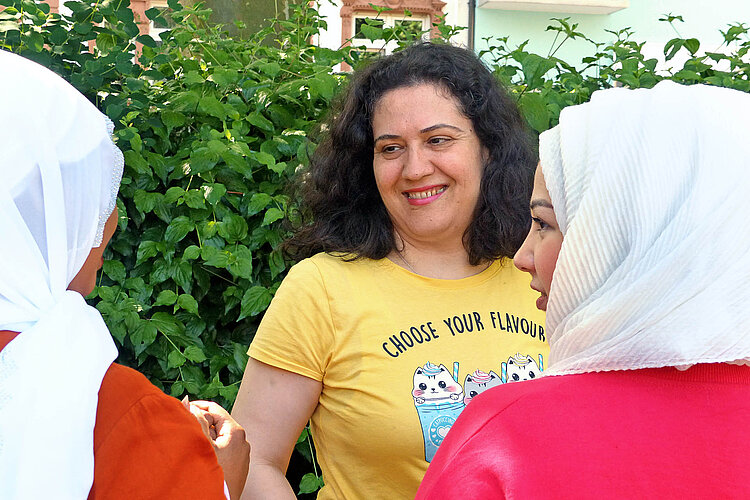 Rose Bilal im Gespräch mit zwei Frauen