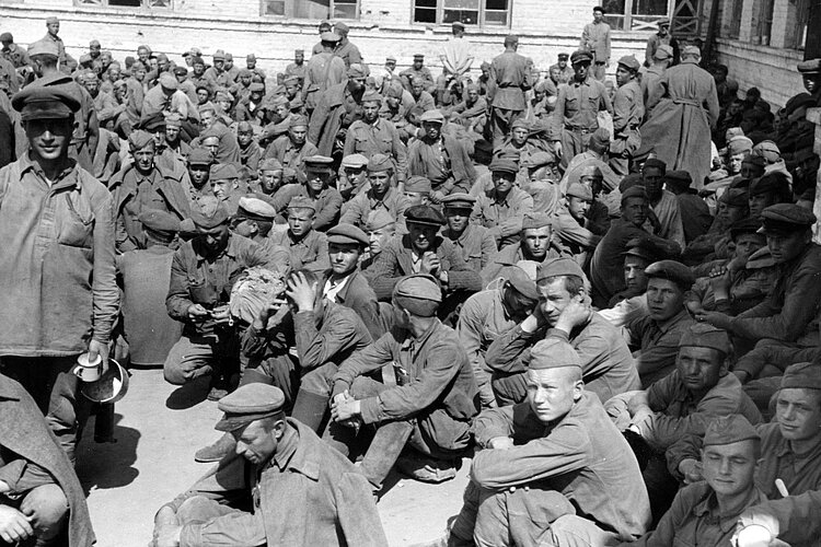 Kriegsgefangene sitzen auf Boden