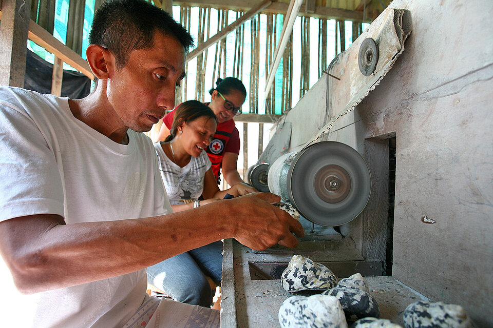 People in front of grinding machine