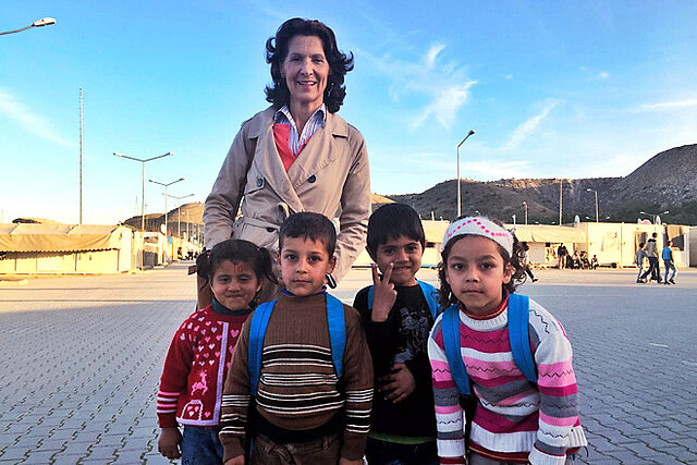 Foto: Antonia Rados in einem syrischen Camp mit vier Kindern vor sich
