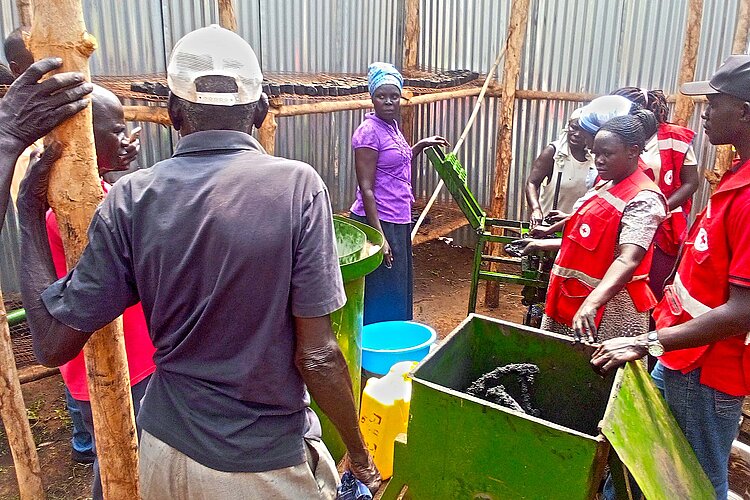 Group around a machine with raw materials