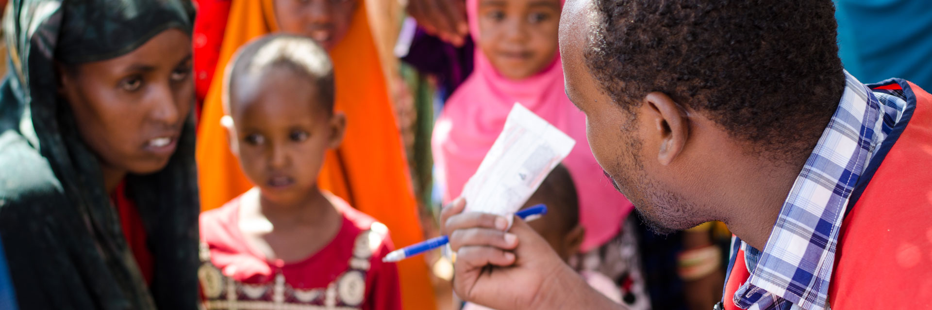 Foto: Rothalbmondarzt gibt Medikament an somalische Familie aus.